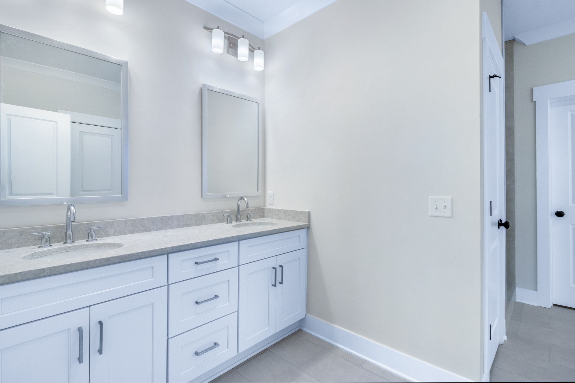 a bathroom with two sinks and two mirrors .