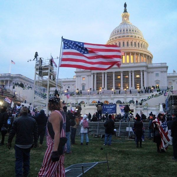 United States Capitol outside protesters with US flag on January 6, 2021. Source: Tyler Merbler; Wikimedia Commons