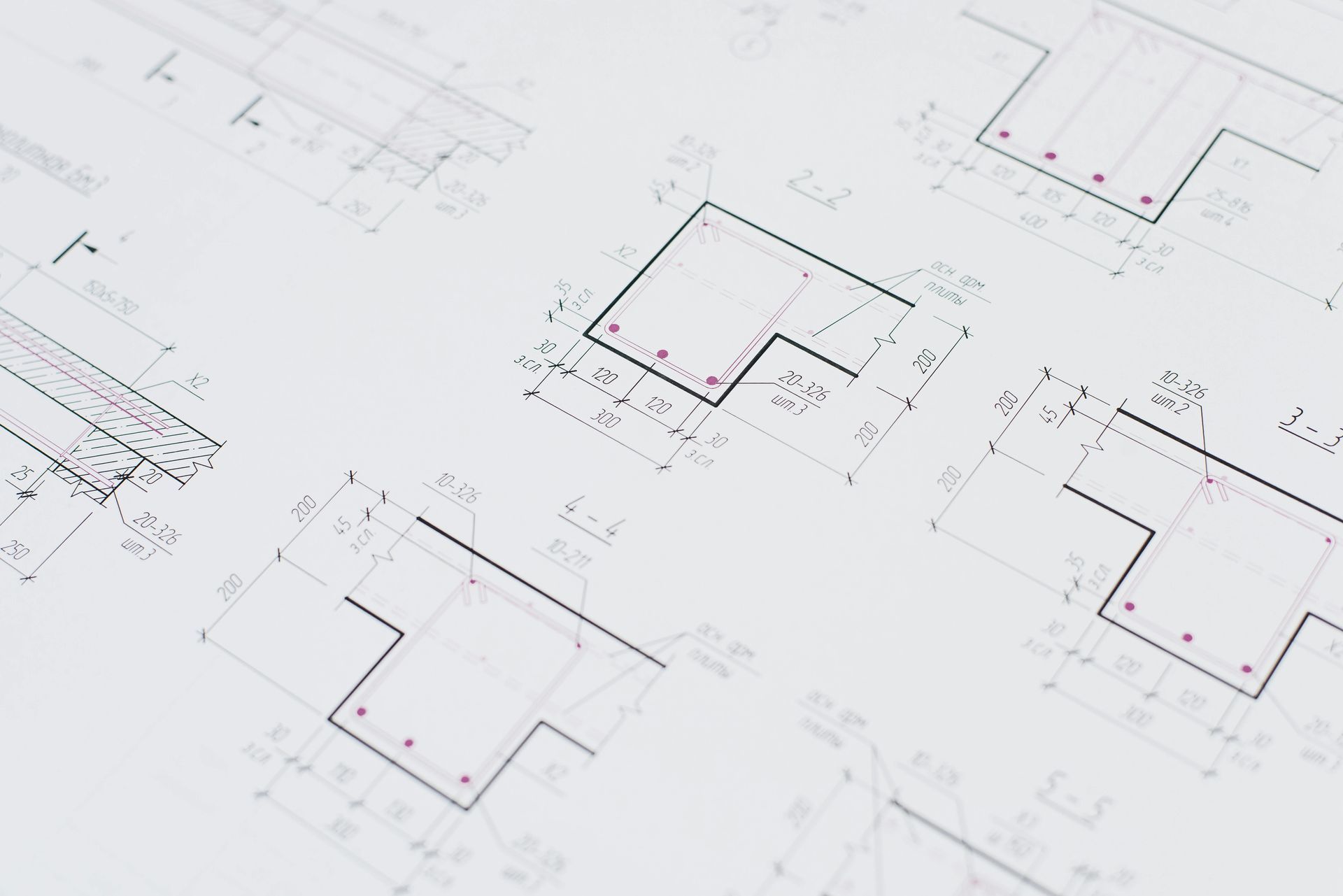 Light gray background with several scattered black floor plan drawings and red measurement marks