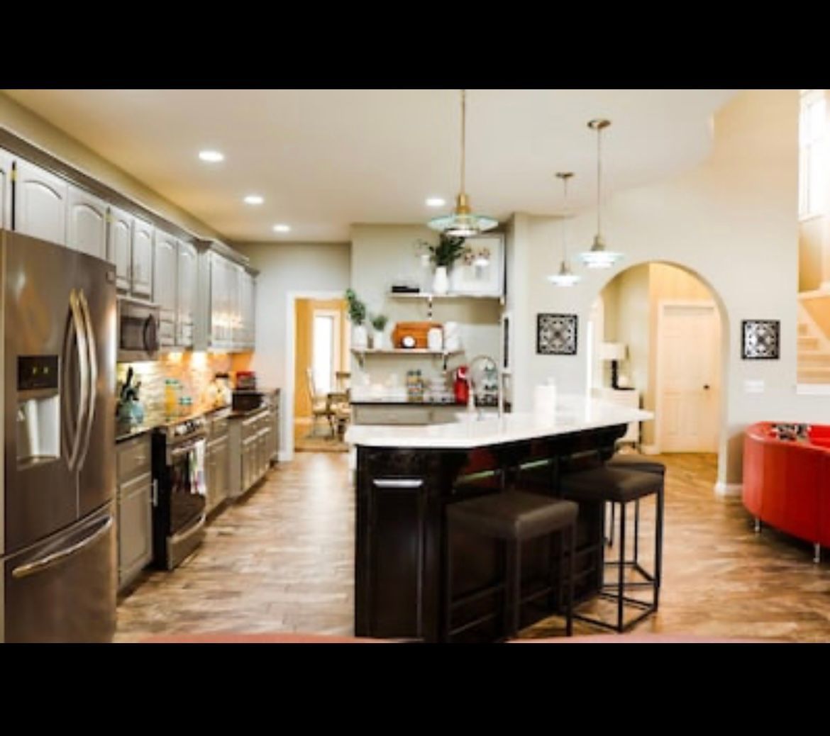 A kitchen with stainless steel appliances and a large island