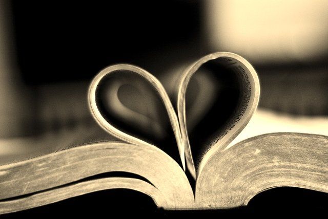 An open book with the pages folded into the shape of a heart
