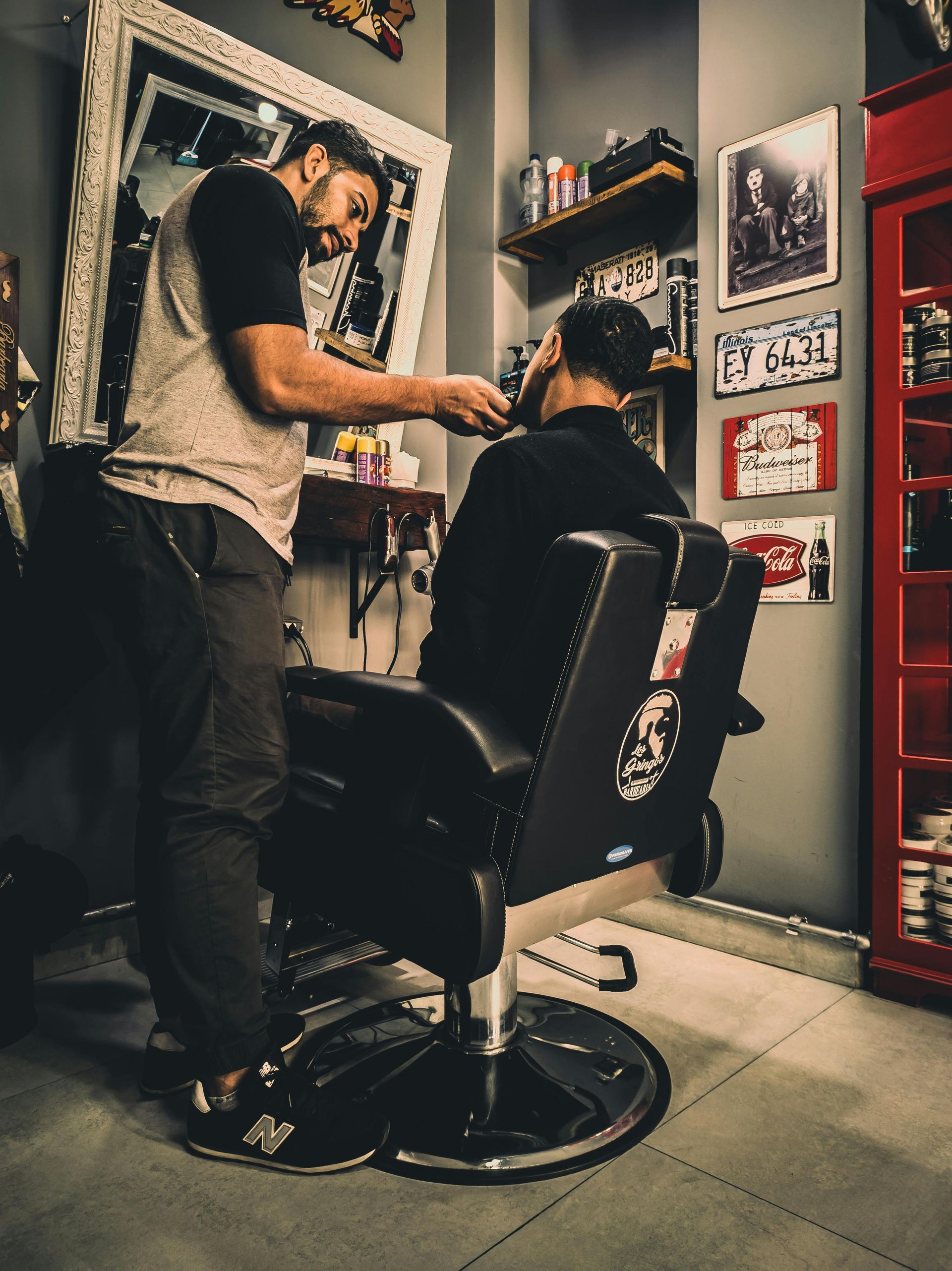 A barber 's tools are laid out on a wooden table.