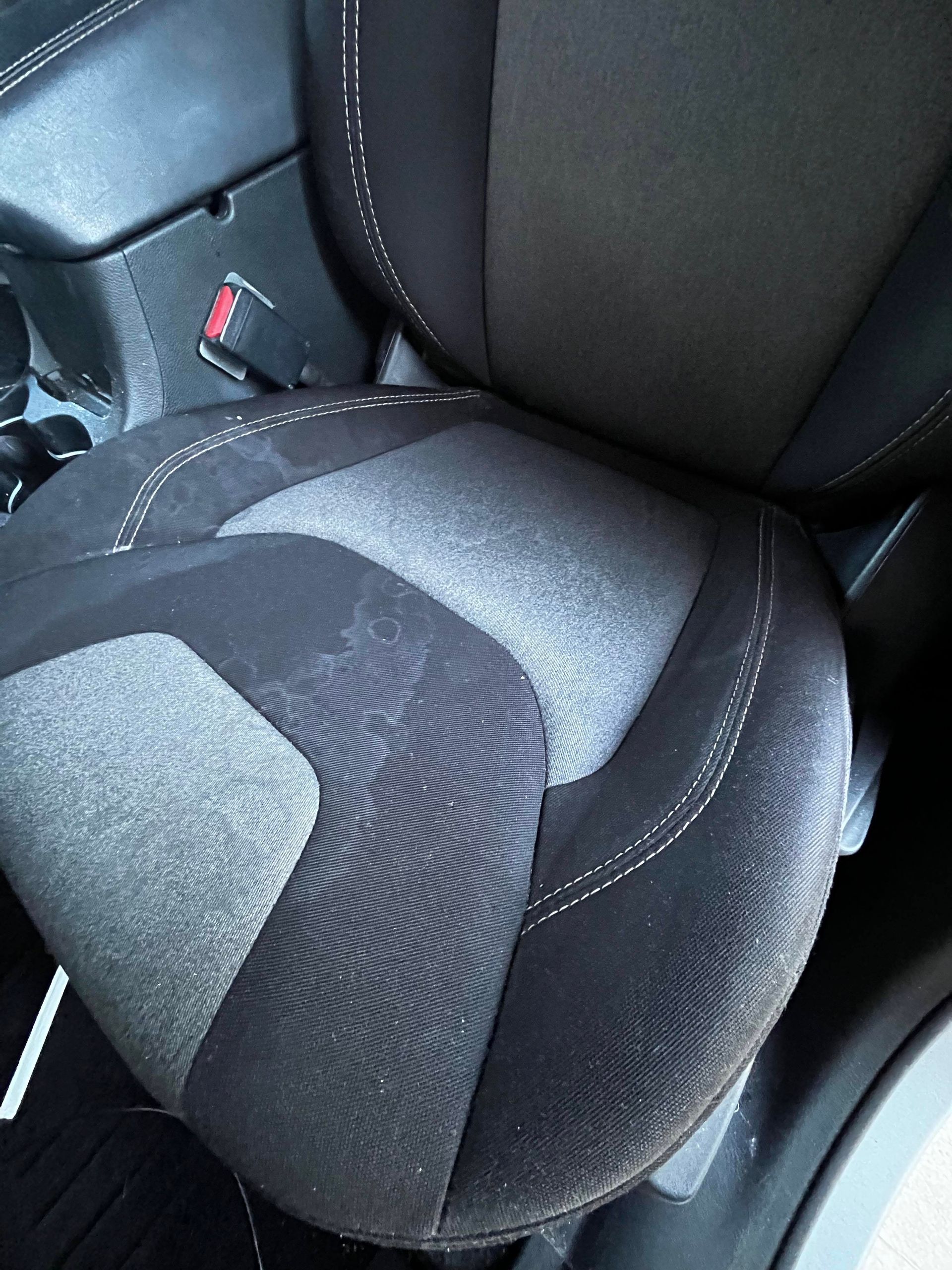 Burgundy Ram pickup truck parked on a driveway in front of a house.