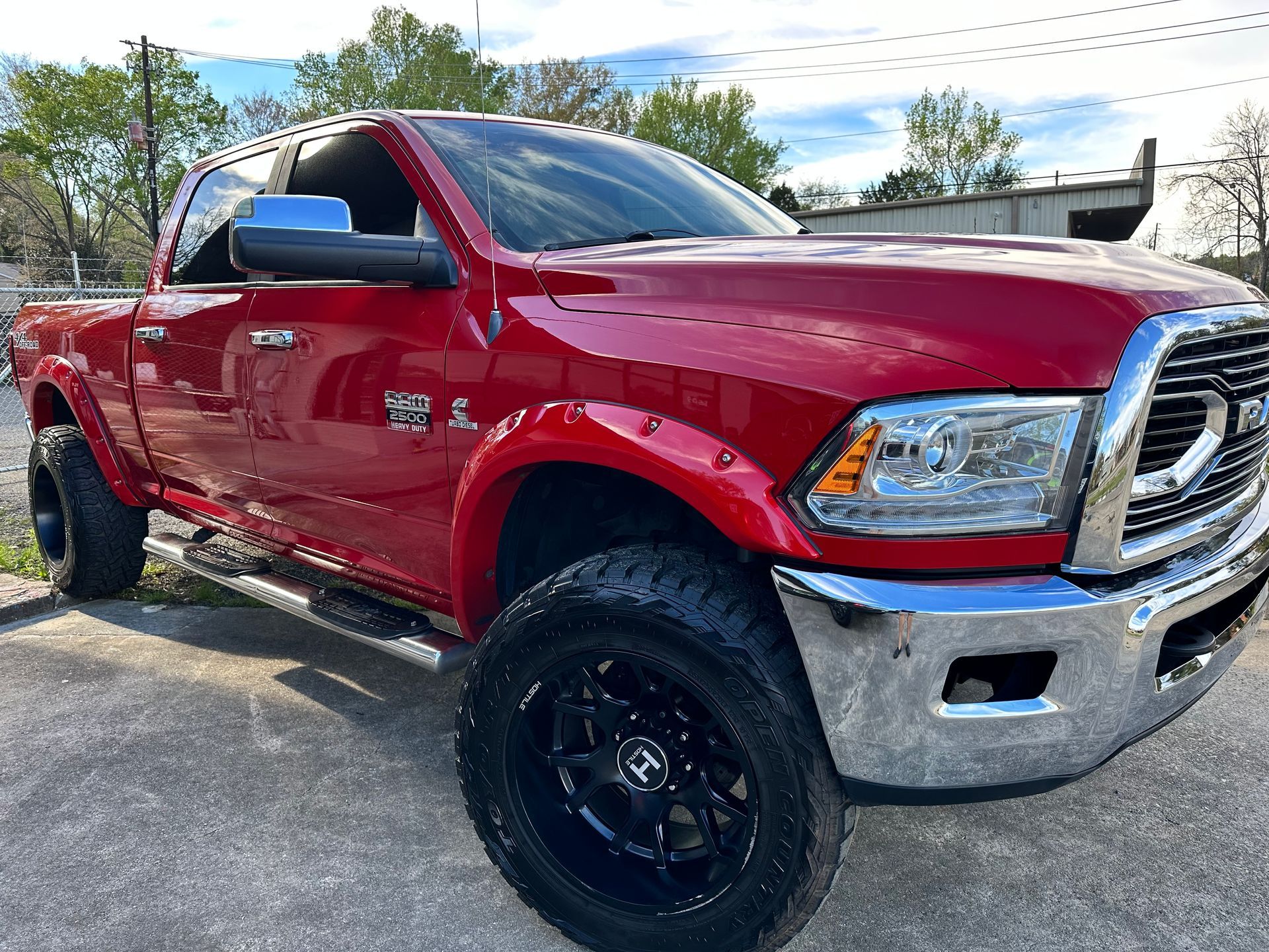 Red Ram truck parked on concrete, with black wheels and chrome accents.