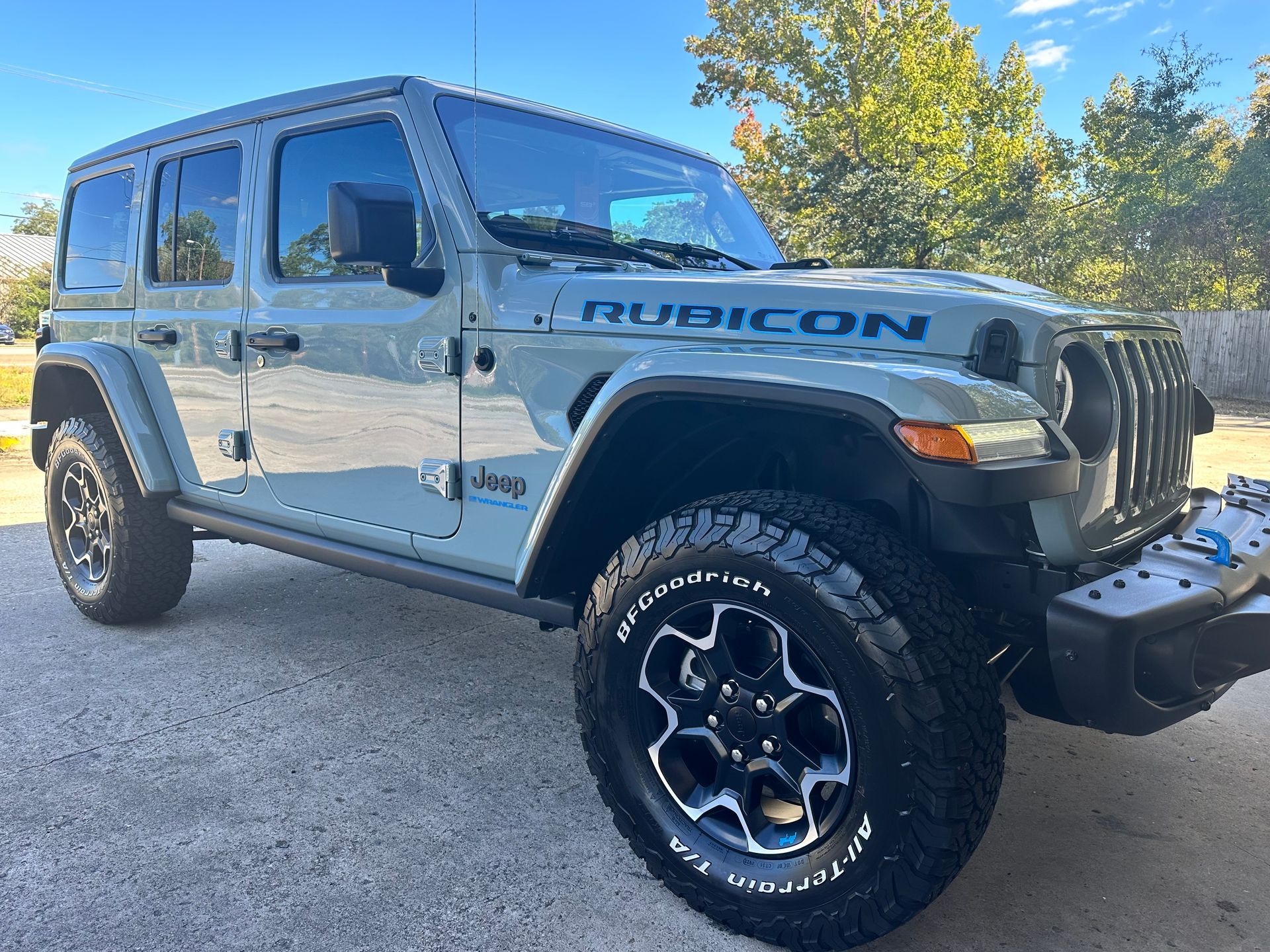 Gray Jeep Rubicon parked on a paved surface with BFGoodrich tires; sunny day.