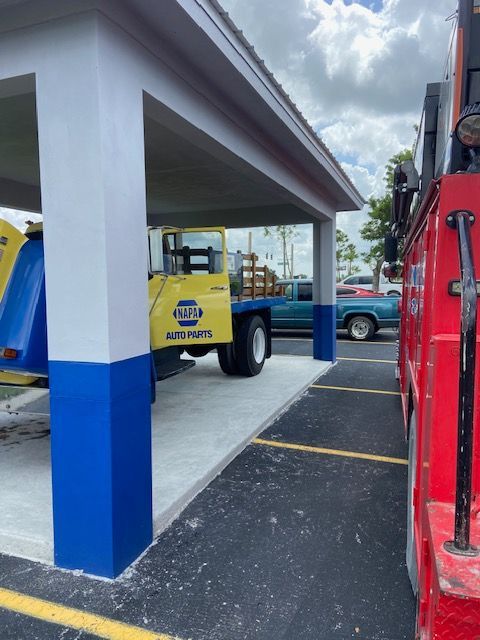 NAPA Auto Parts truck parked under a covered structure with a blue, white, and gray color scheme