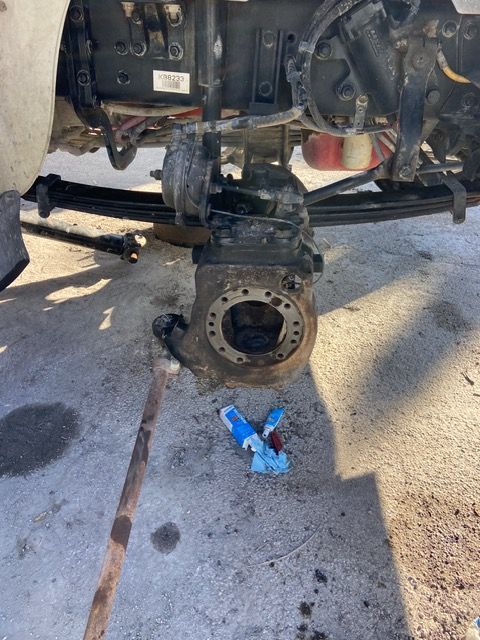 Underside of a heavy-duty truck with a wheel removed, exposing the brake assembly and suspension.