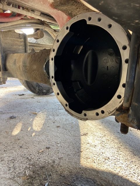 Open differential housing on a vehicle, showing the inside. Black interior, gray exterior.