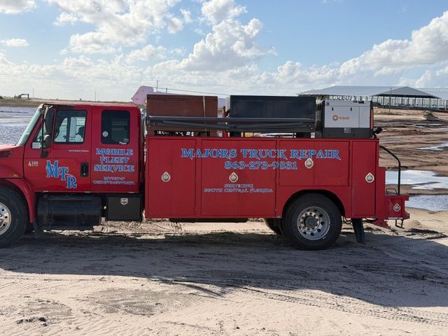 Tires on a tanker truck partially off the road, with a 