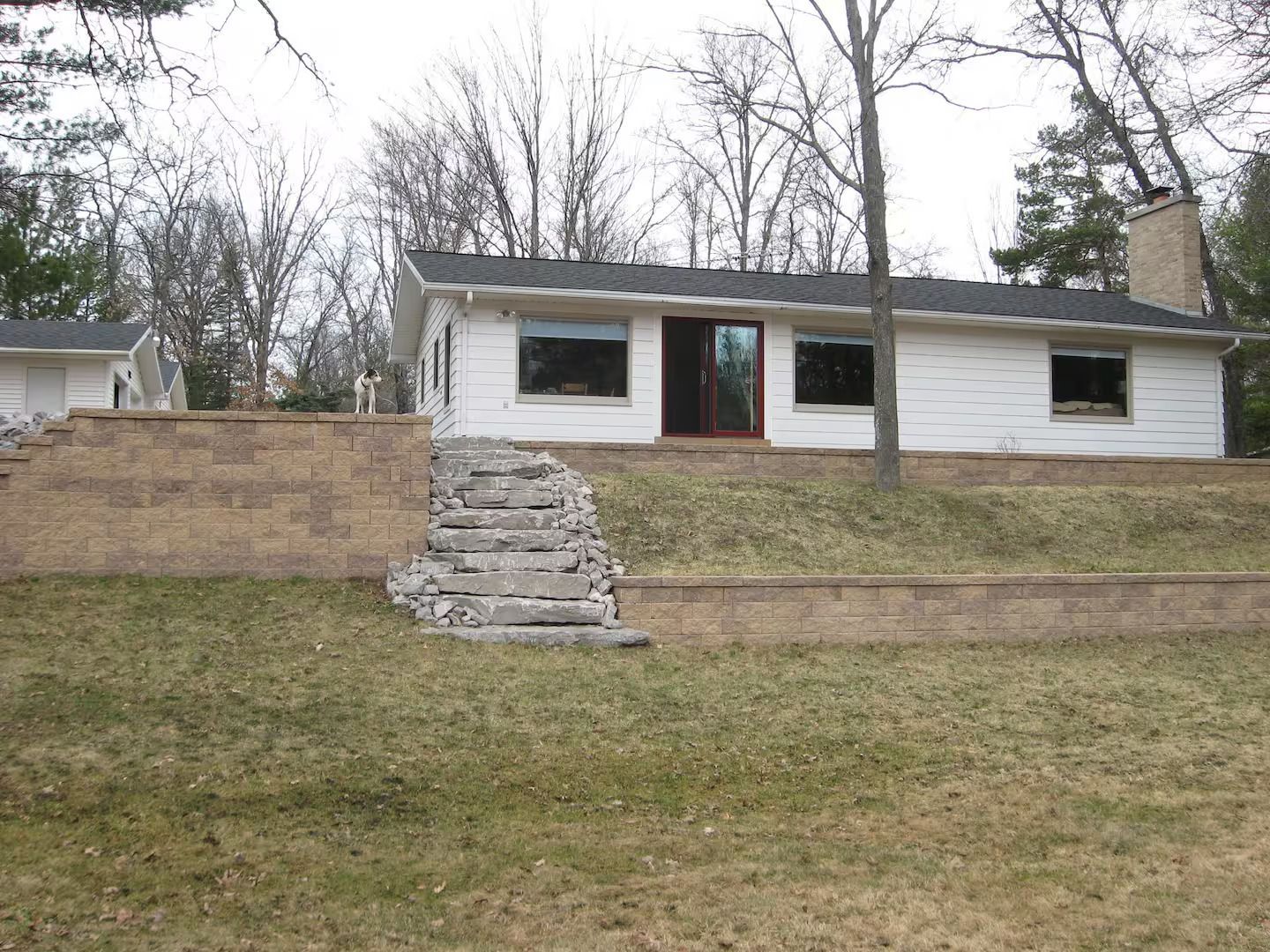 A white house with stairs leading up to it