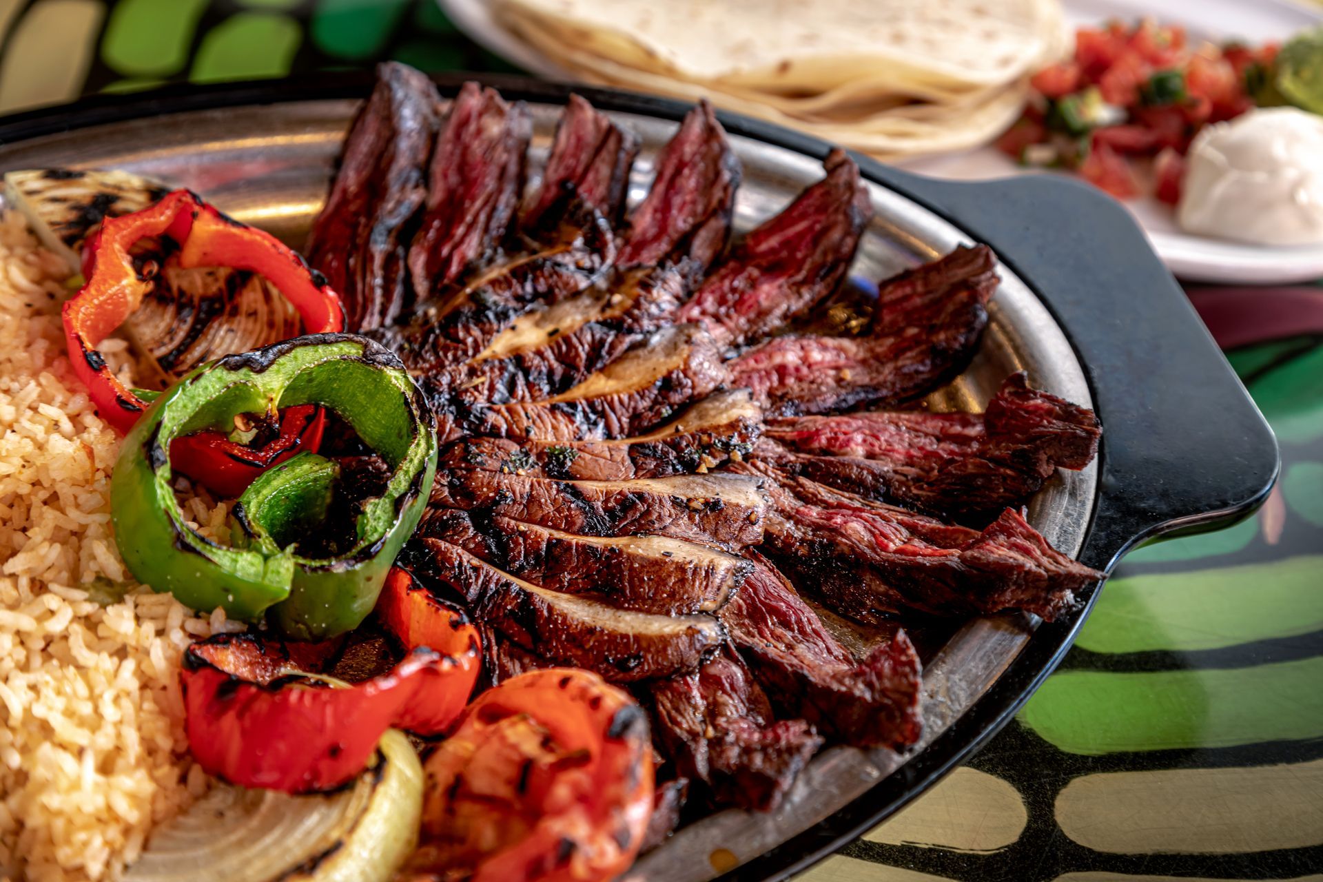 A plate of food with meat and vegetables on a table.