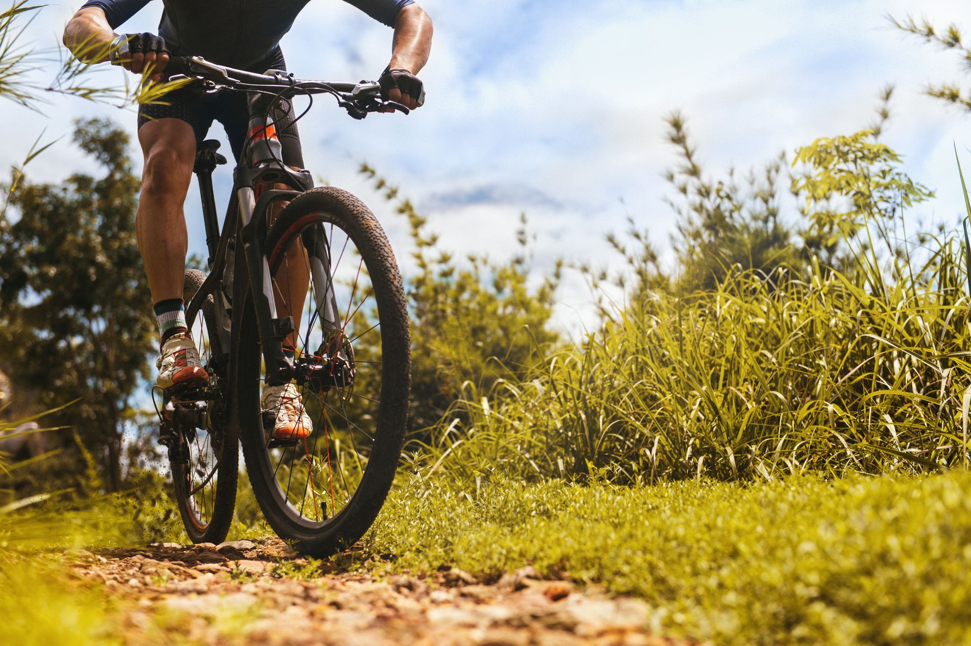 A man is riding a mountain bike on a dirt trail.