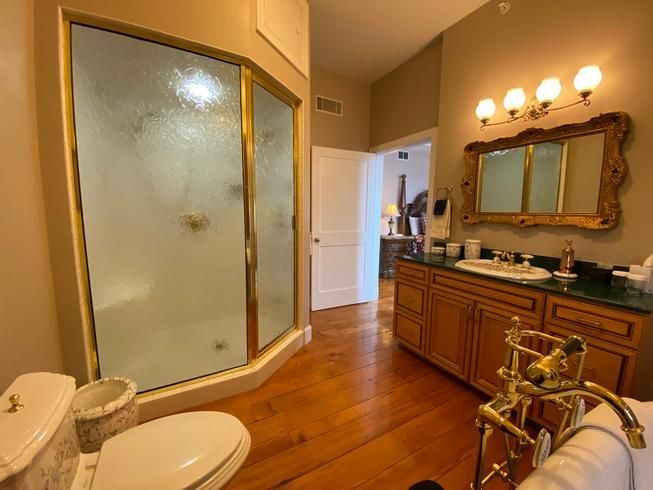 A bathroom with a toilet , sink , and walk in shower.