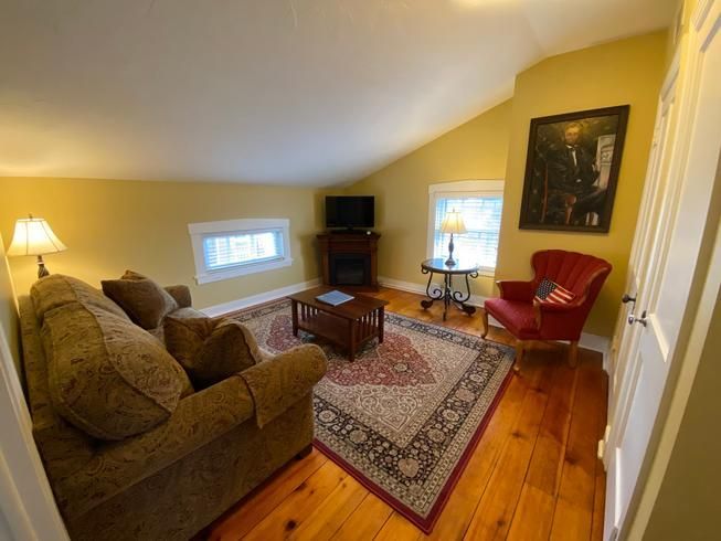 A living room with a couch a chair and a television