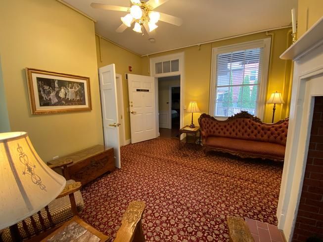 A living room with a couch and a lamp