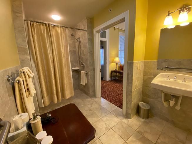 A bathroom with a sink , shower , and mirror.