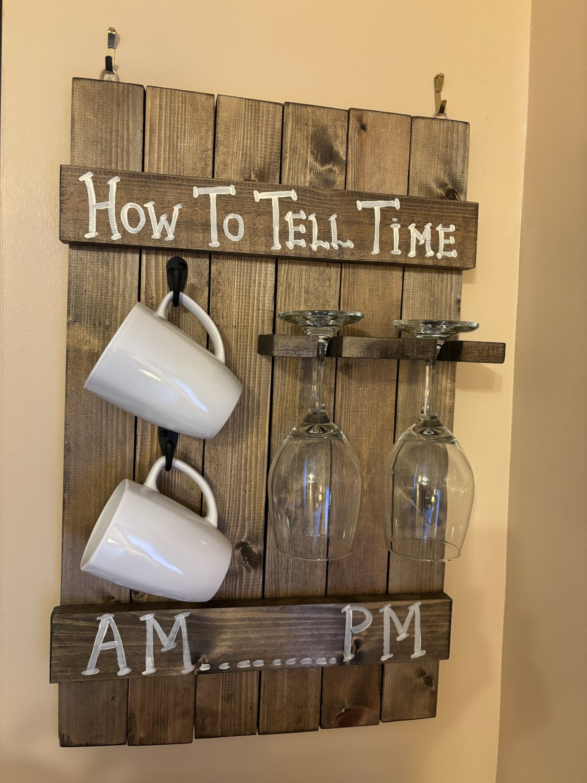 A wooden sign that says how to tell time hangs on a wall.