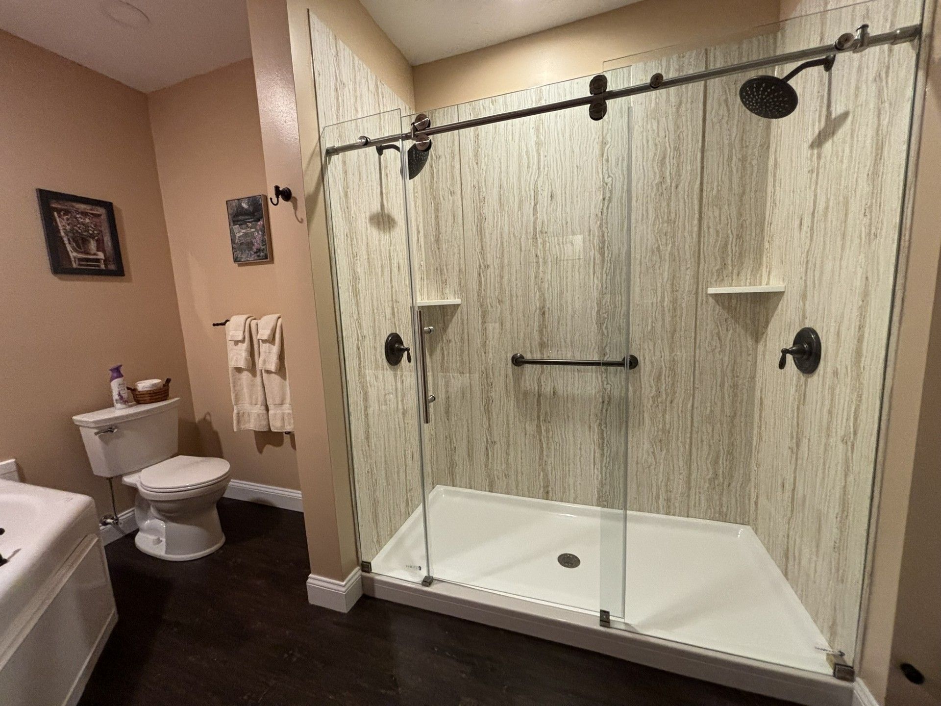 A bathroom with a walk in shower and a toilet.