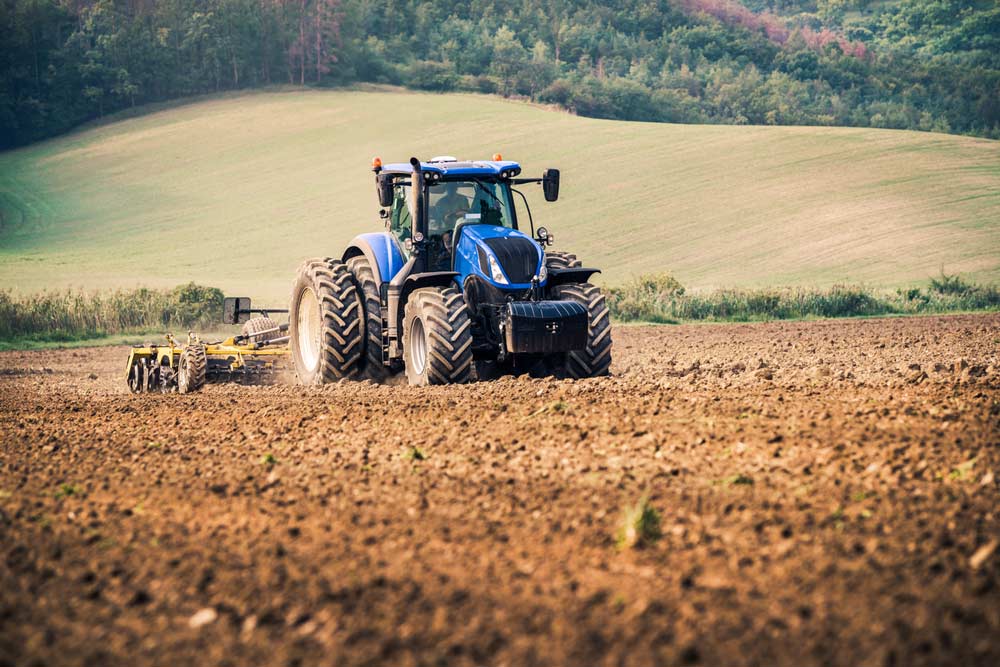Modern Blue Tractor on the Field — Diesel Fitter and Mechanic In Bundaberg East, QLD