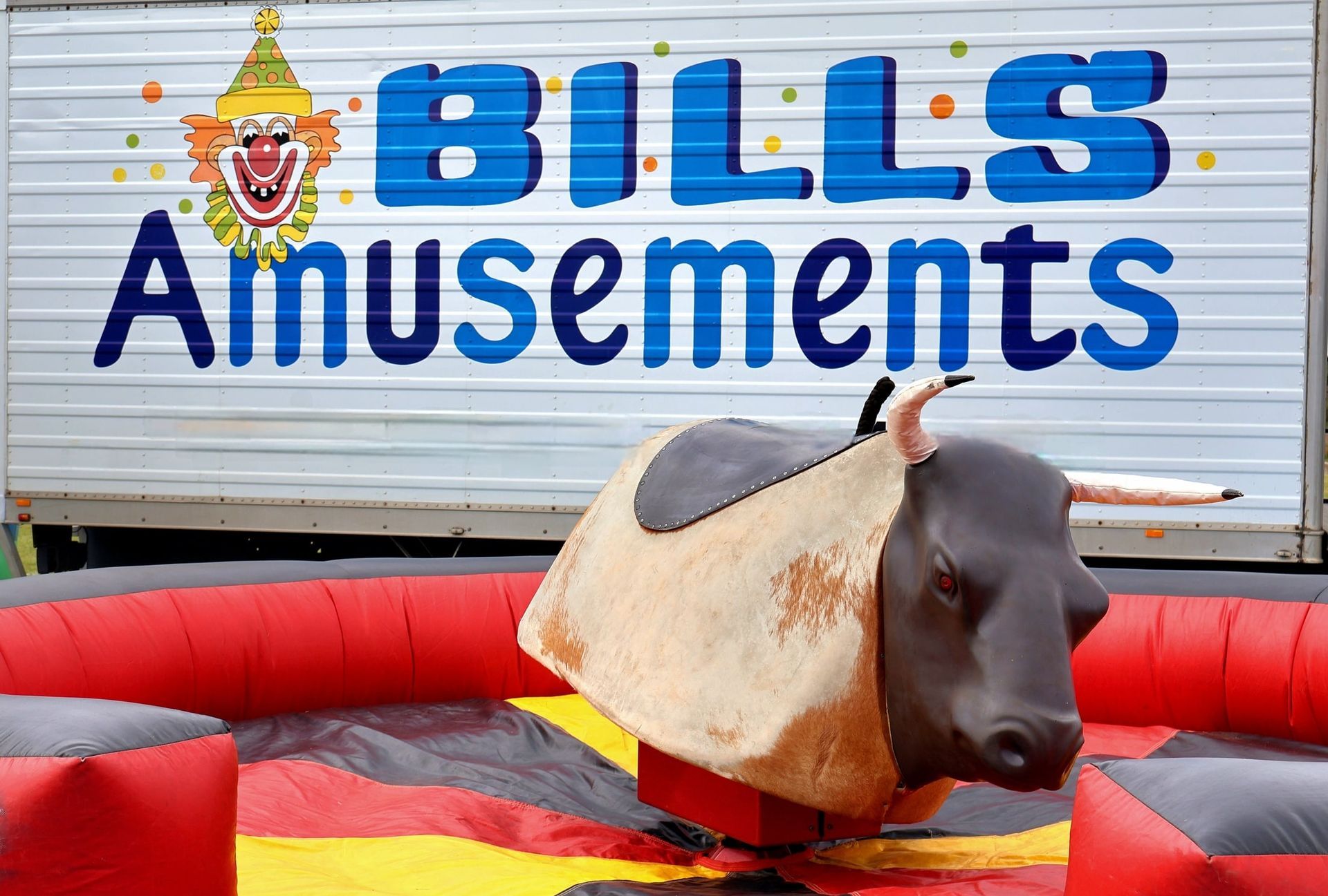 A Mechanical Bull Is Sitting In Front Of A Bills Amusements Sign — Bills Amusements In Rockhampton, QLD