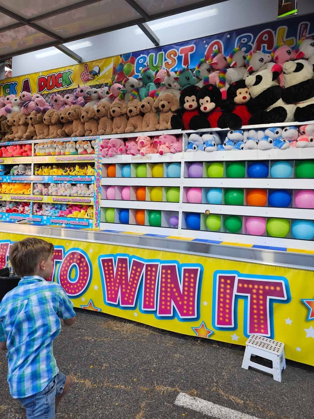 A Boy Is Playing A Game At A Carnival Called To Win It — Bills Amusements In Rockhampton, QLD