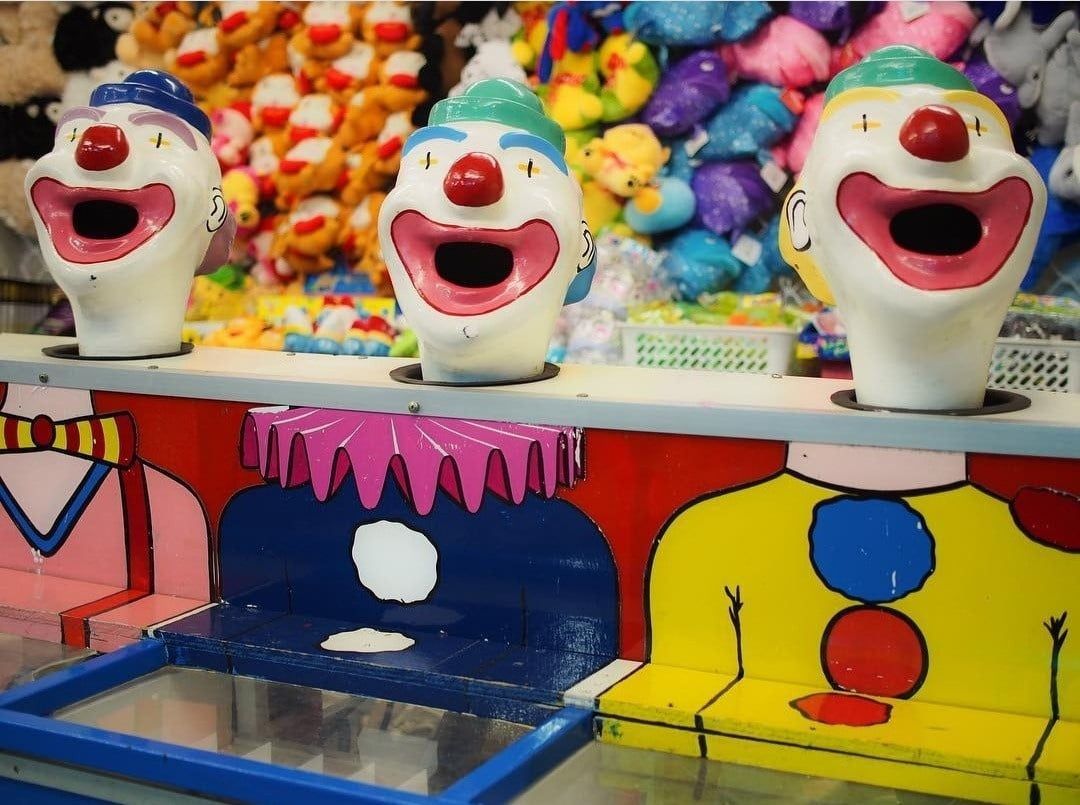 A Row Of Clown Heads With Their Mouths Open — Bills Amusements In Emerald, QLD