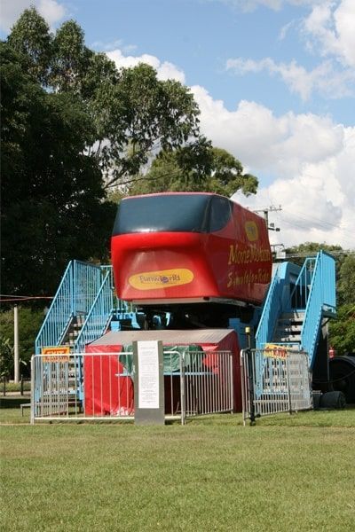 A Red Carnival Ride In A Grassy Field — Bills Amusements In Mackay, QLD