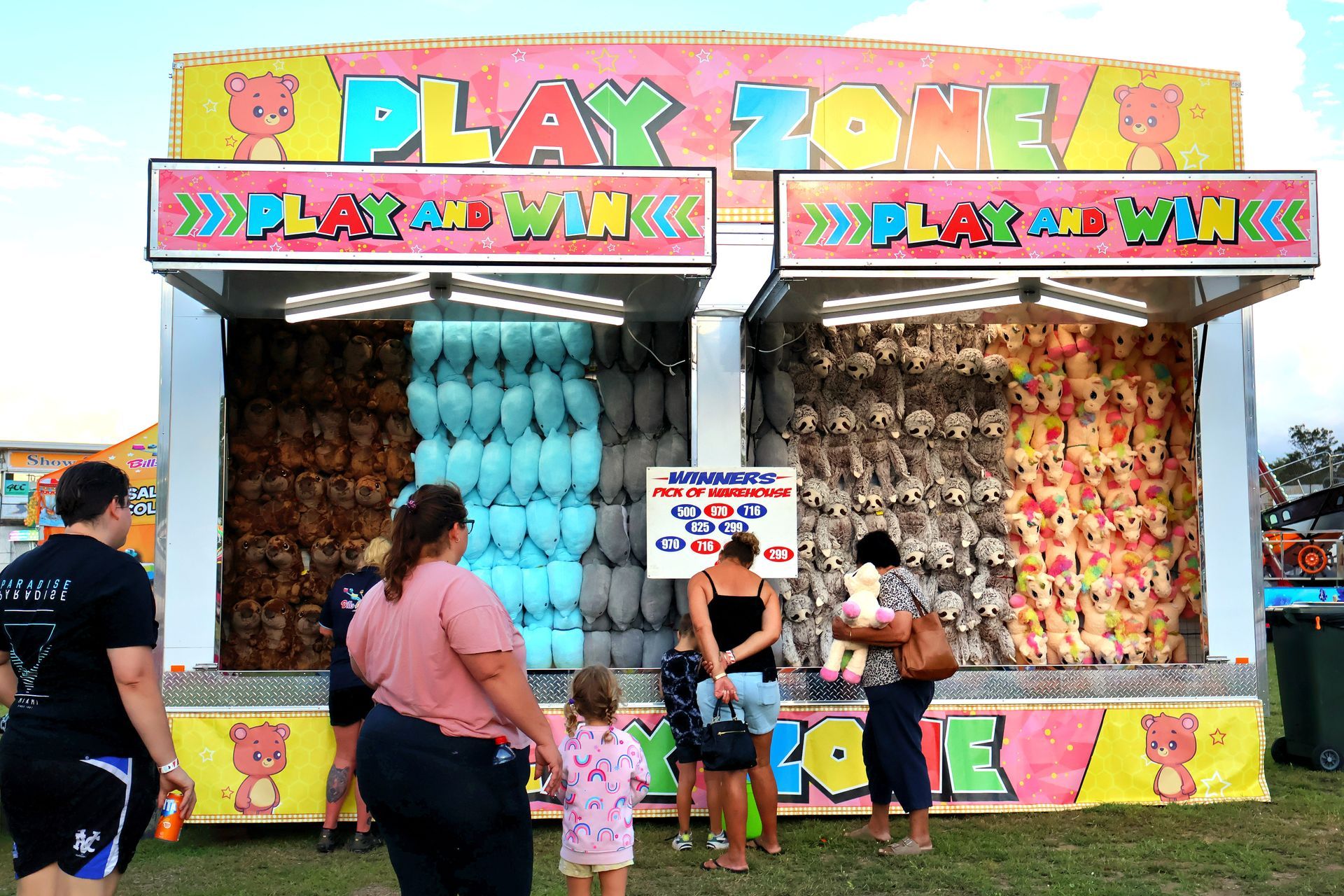 A Group Of People Are Standing In Front Of A Play Zone At A Carnival — Bills Amusements In Rockhampton, QLD