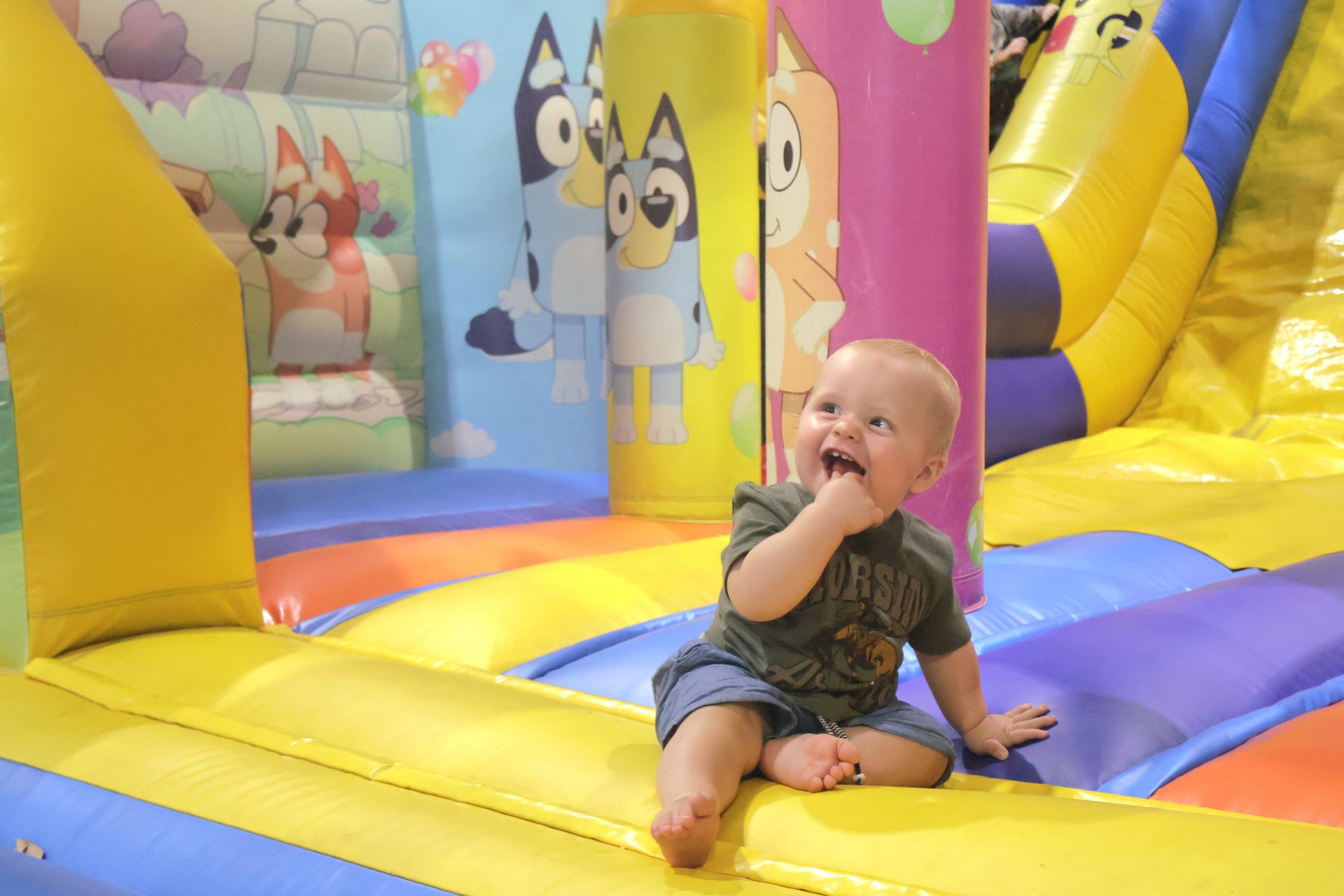 A Baby Is Sitting On Top Of A Bouncy House — Bills Amusements In Rockhampton, QLD