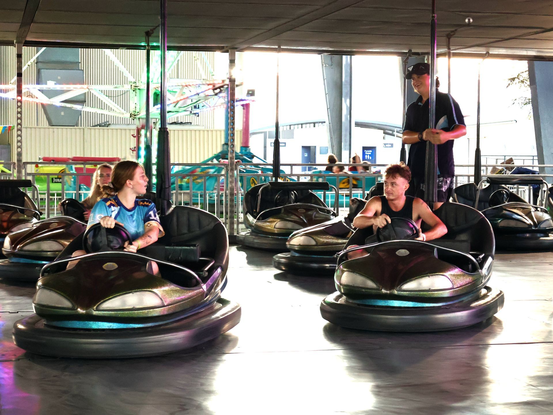A group of people are riding bumper cars at an amusement park — Bills Amusements In Rockhampton, QLD