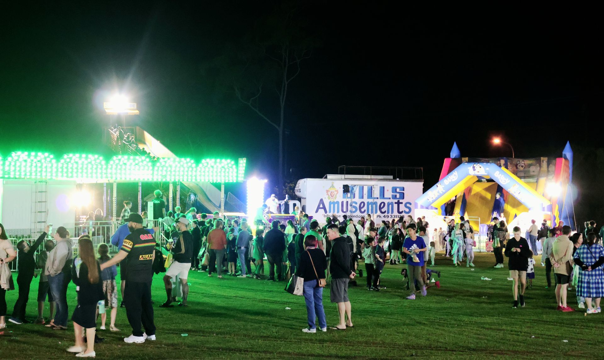 A Group Of People Lining Up At A Carnival — Bills Amusements In Rockhampton, QLD