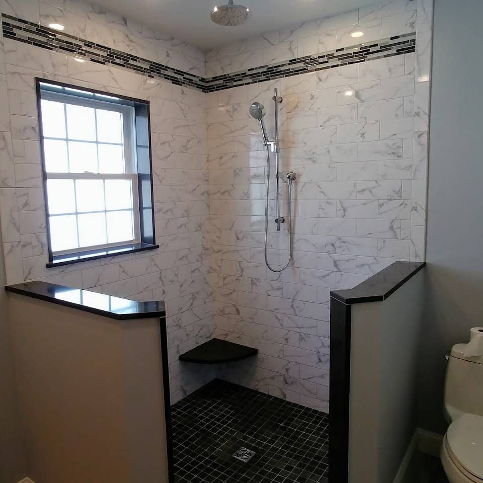 A bathroom with a walk in shower and a toilet