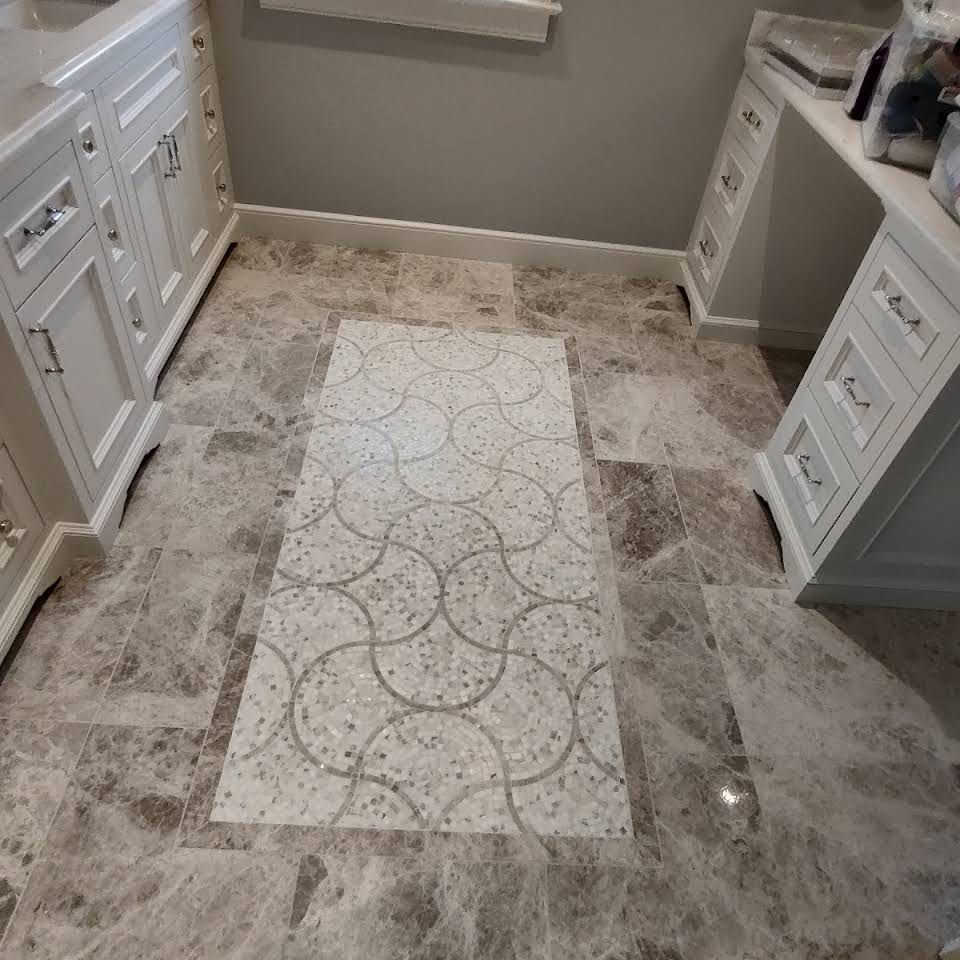 A tiled floor with a geometric pattern in a bathroom