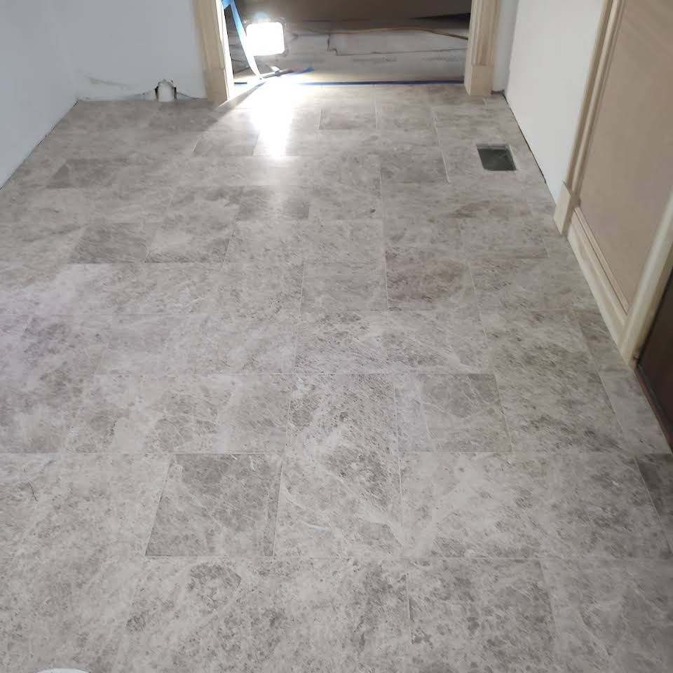 A room with a tiled floor and a white wall.