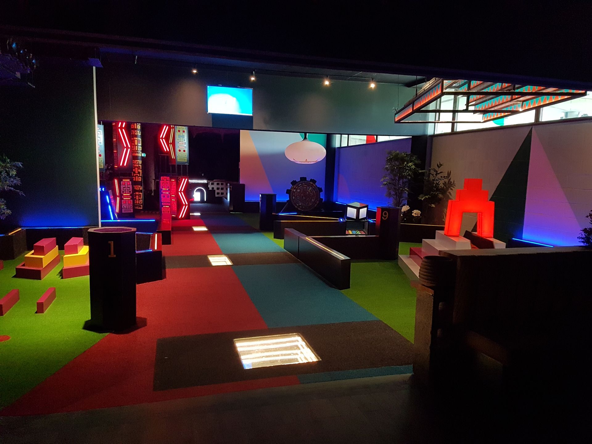 A dark room with a lot of lights on the walls