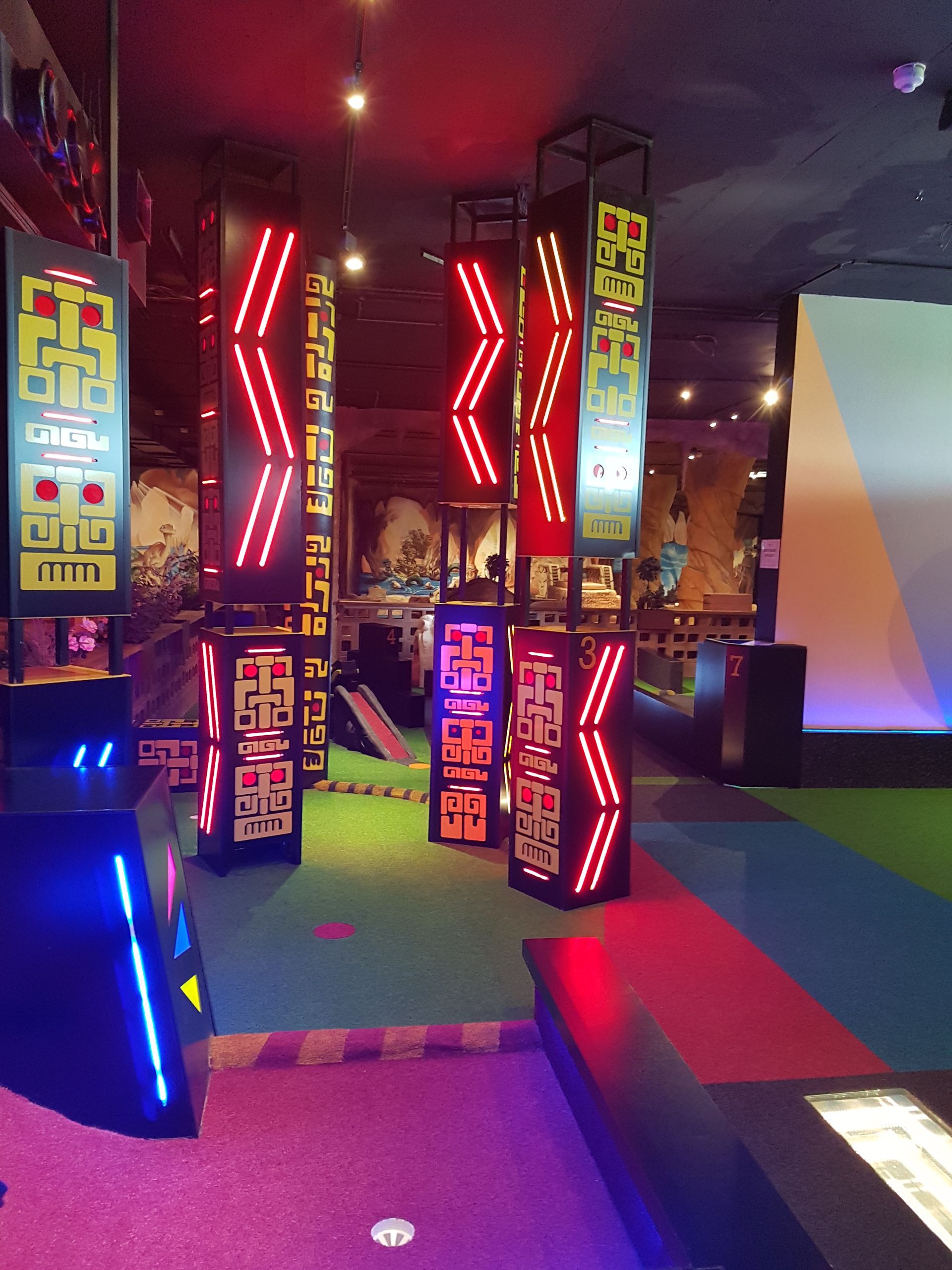A colorful room with a sign that says ' arcade ' on it