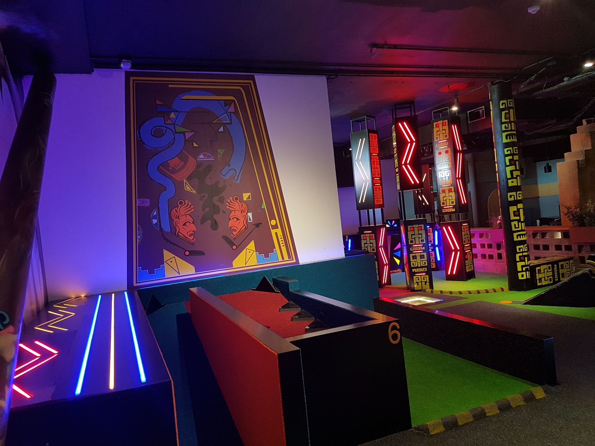 A room with a lot of lights on it and a painting on the wall.