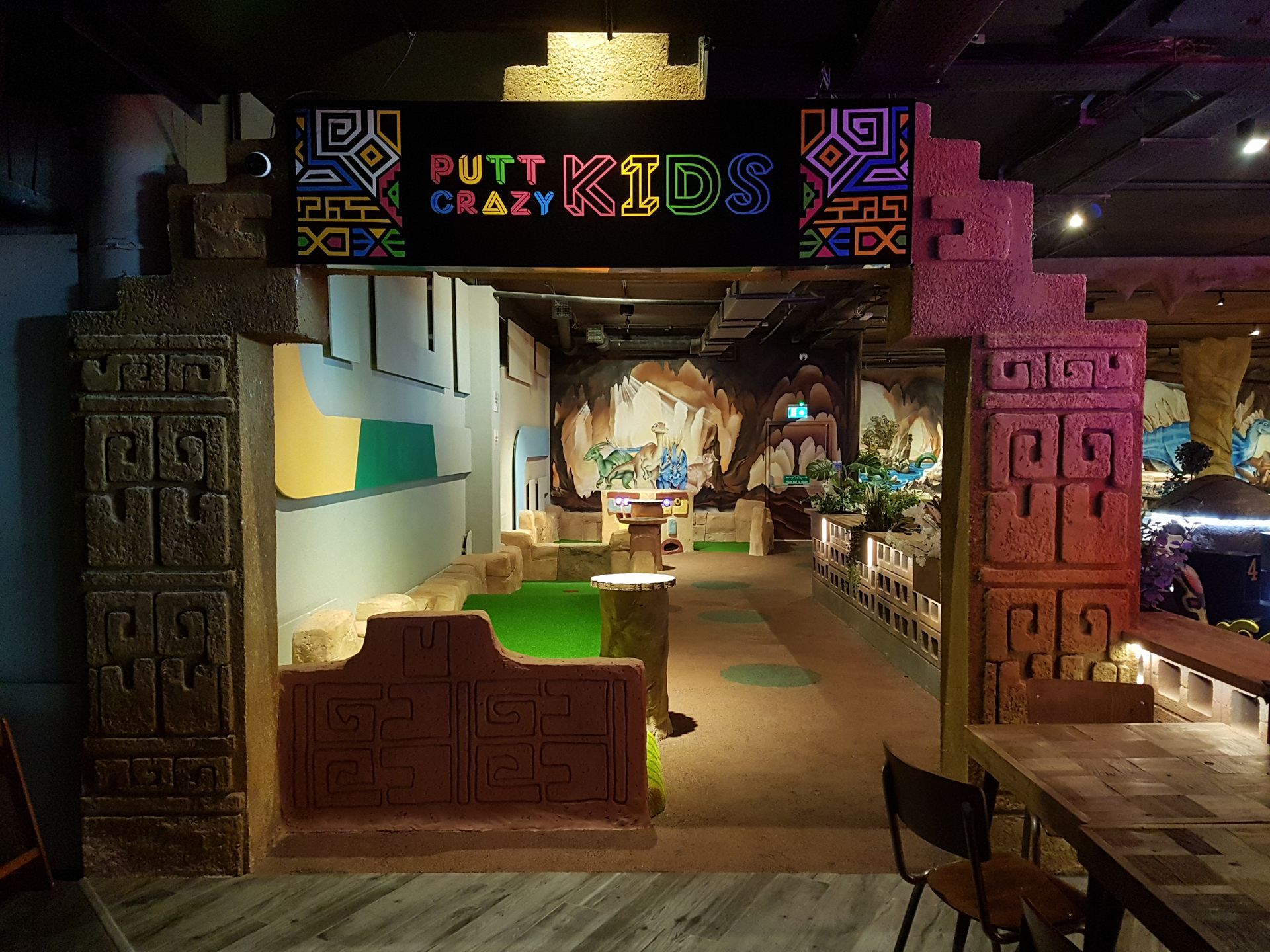 A restaurant with a sign that says putt kids crazy kids