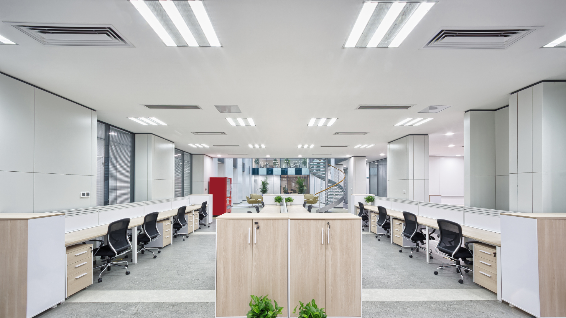 A large office with a lot of desks and chairs.