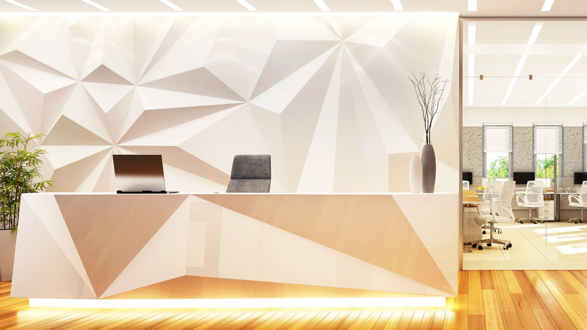 A reception desk in an office with a white wall and wooden floor.