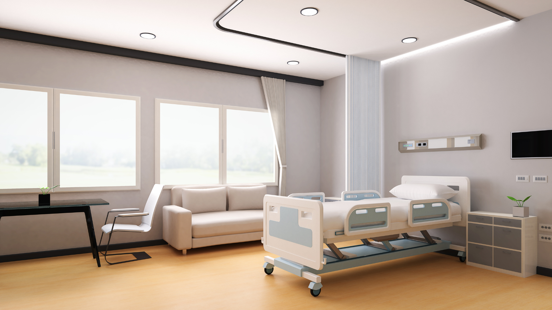 A hospital room with a bed , couch , chair and television.