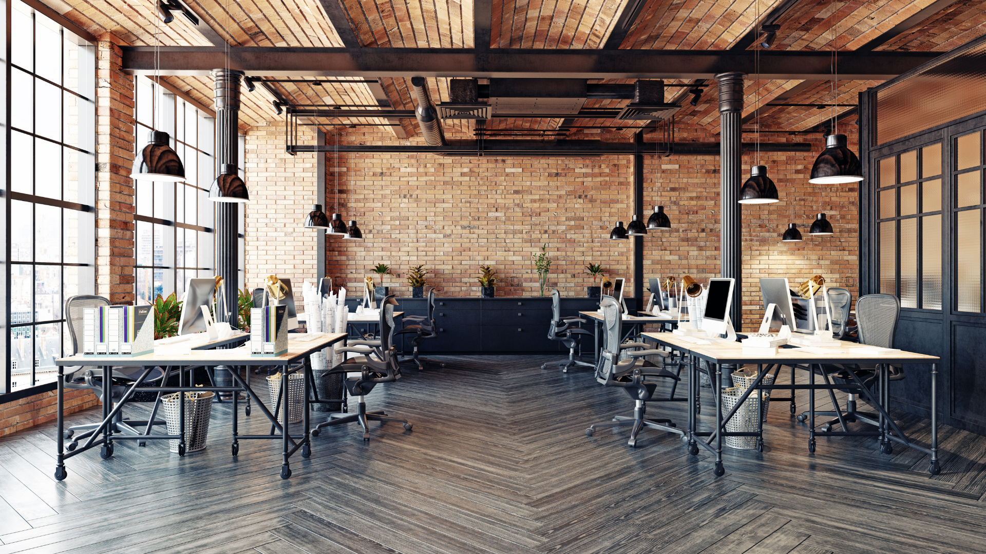 An empty office with tables and chairs and a brick wall.