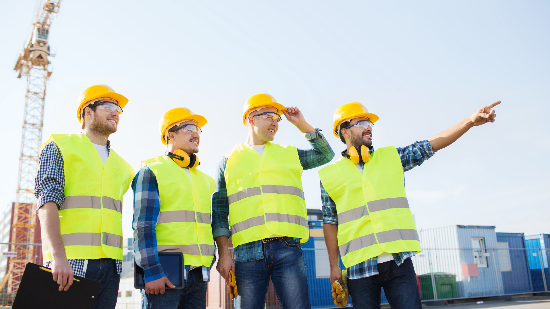 A group of construction workers are standing next to each other on a construction site.