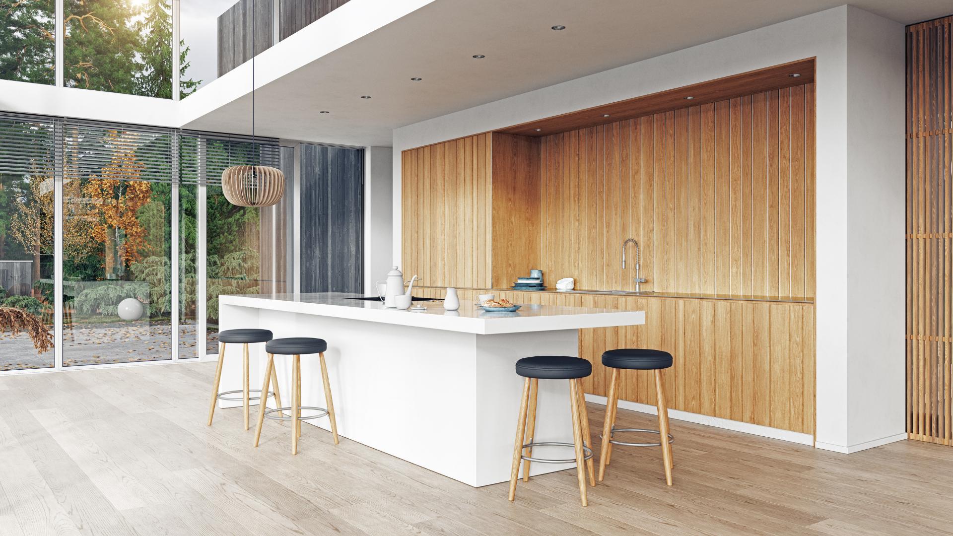 A modern kitchen with wooden cabinets and stools and a large island.