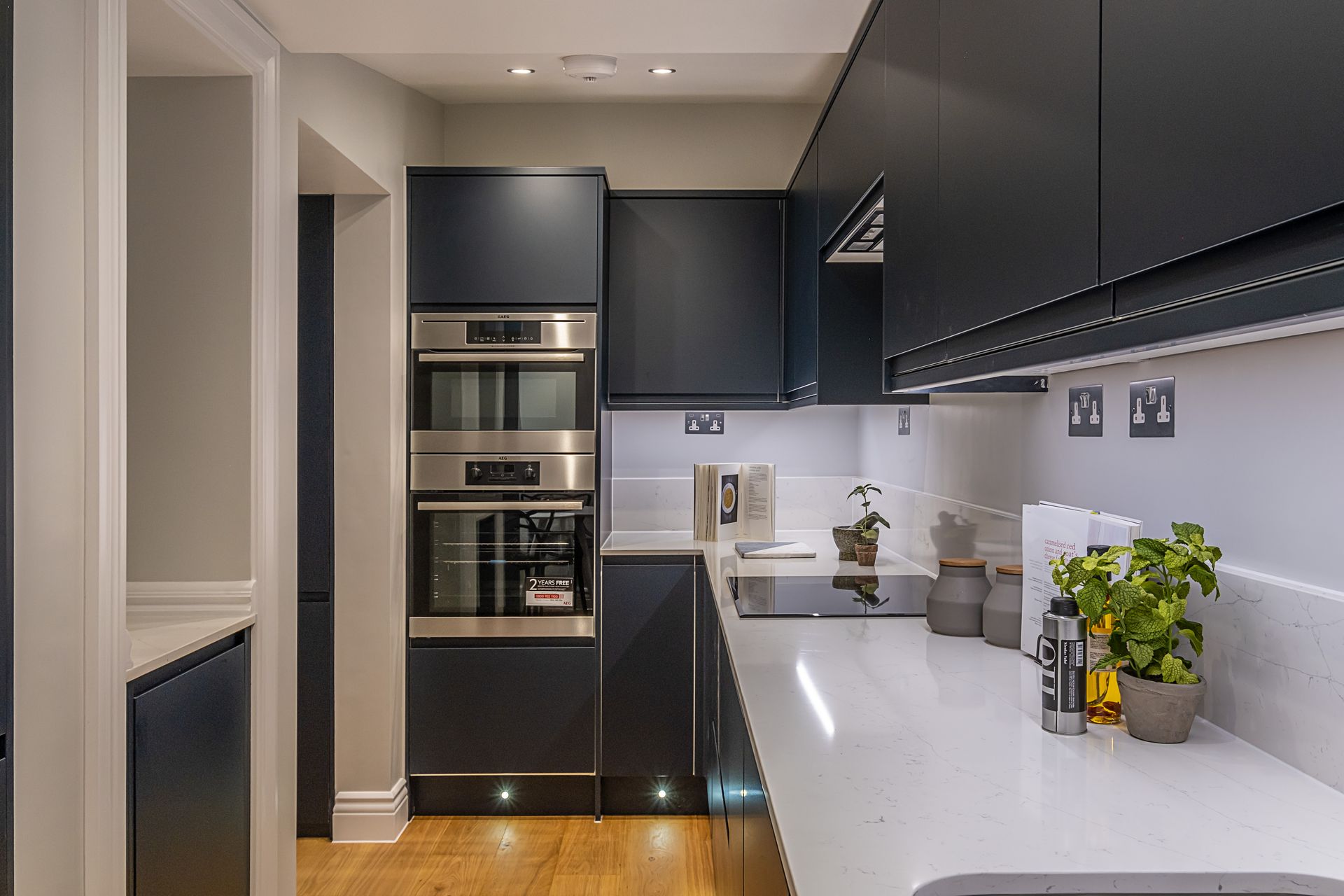 A kitchen with blue cabinets and stainless steel appliances.
