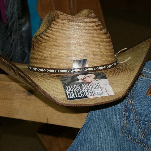 A cowboy hat resting on a wooden table.