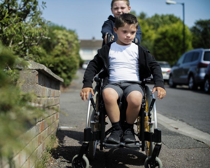 Boy Pushing His Brother in a Wheelchair — VIC & NSW — KaizenCare