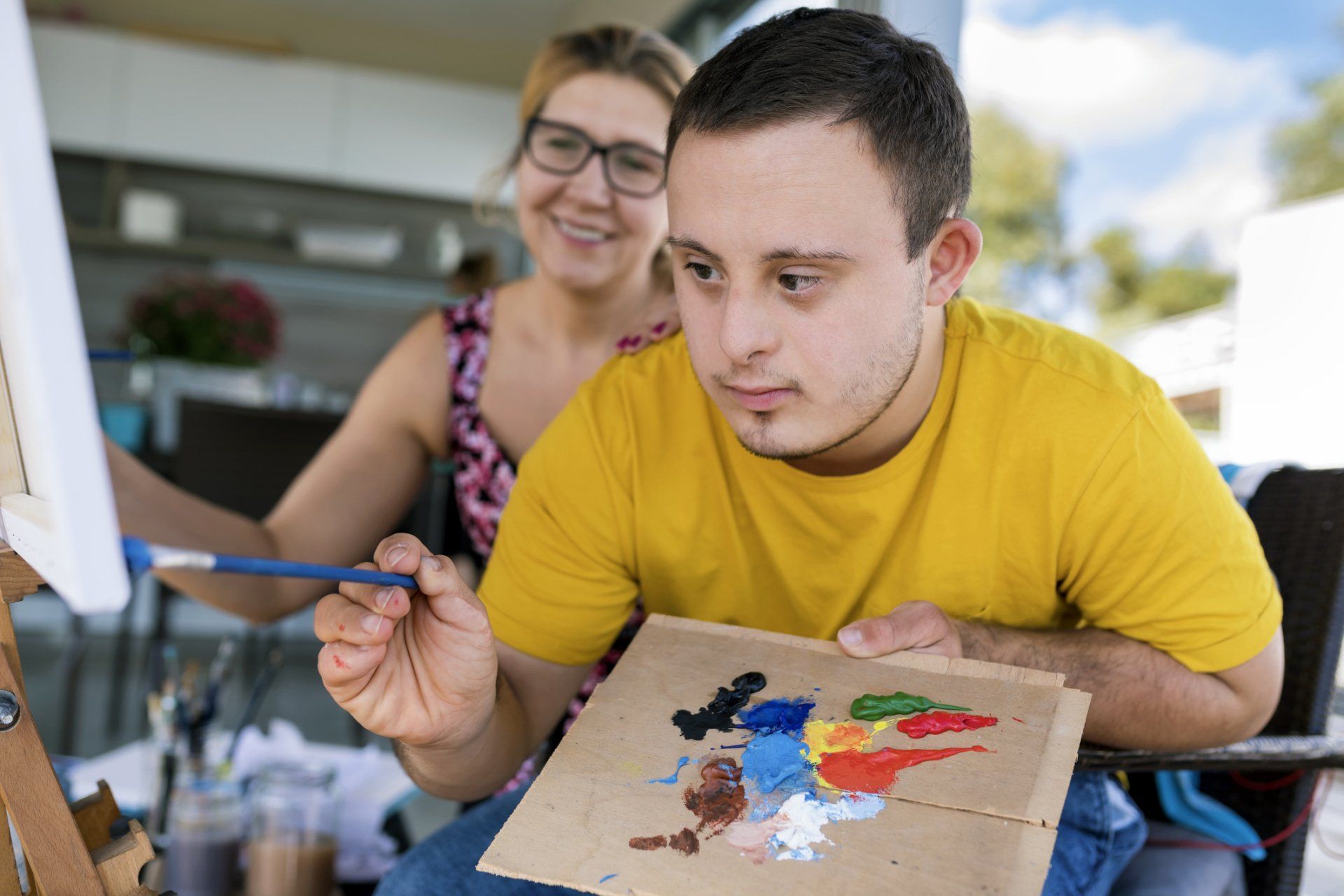 Boy with Down Syndrome Painting — VIC & NSW — KaizenCare