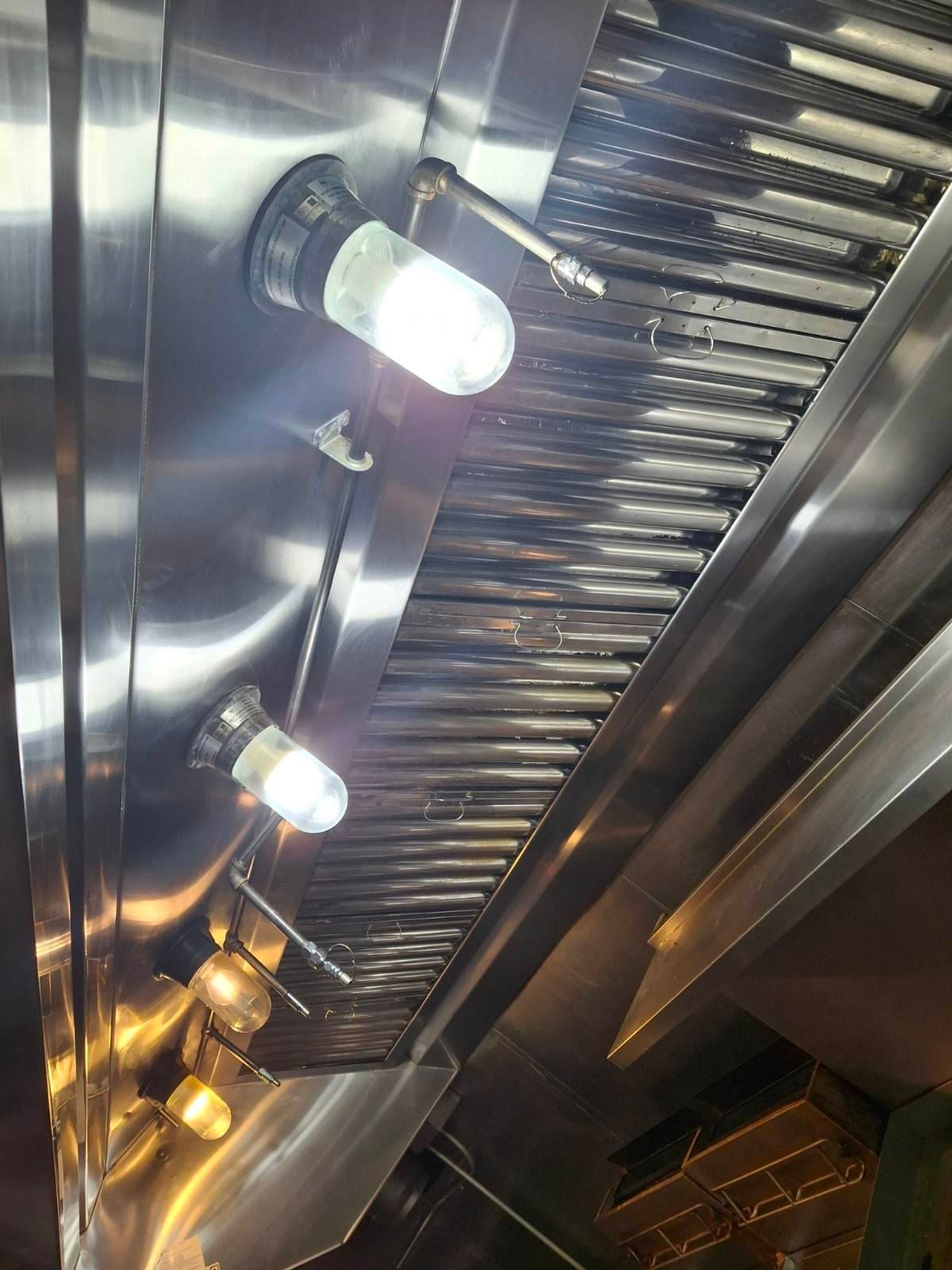 Family gathered at a dining table in a kitchen. They are eating and talking together.
