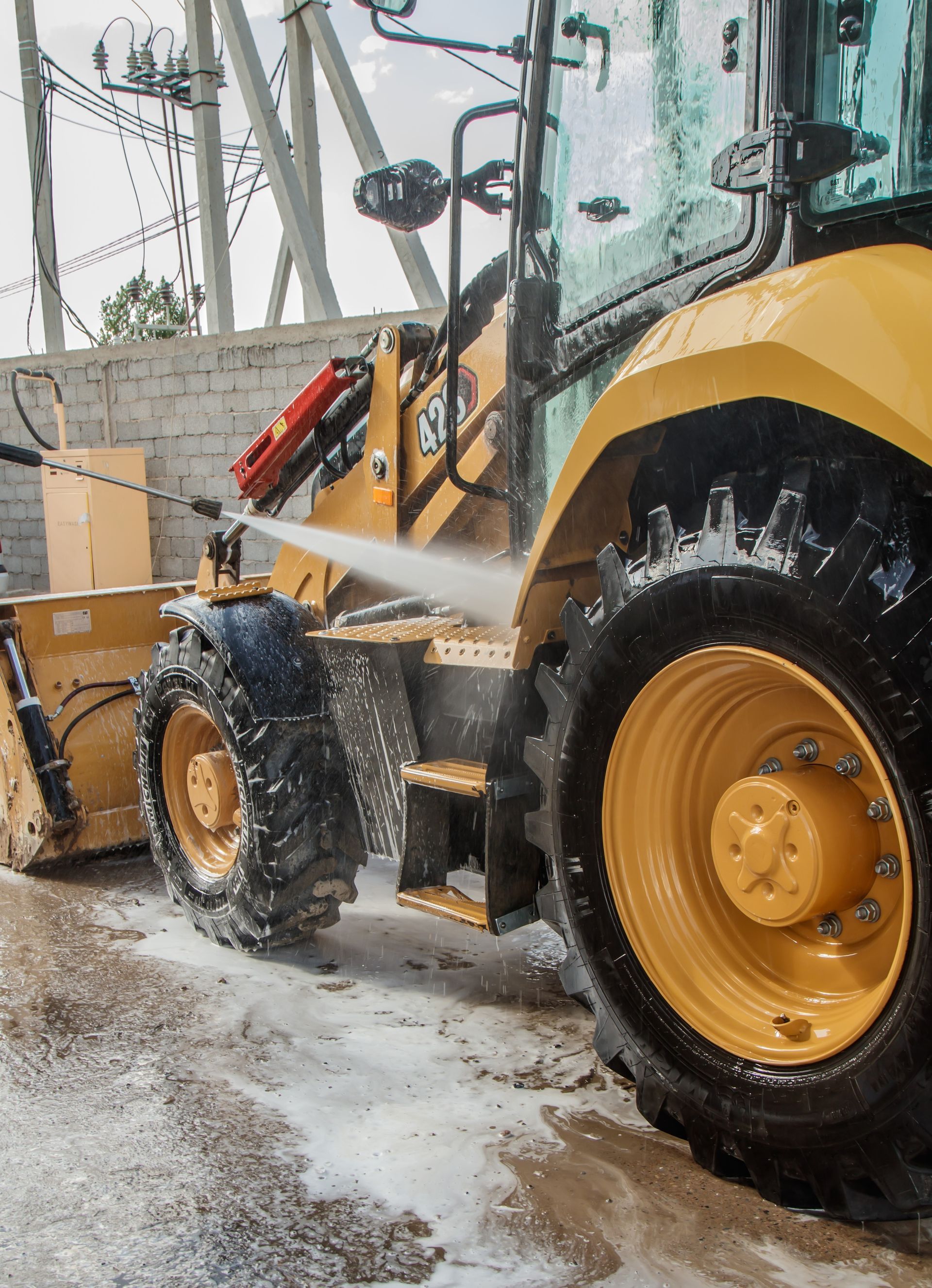 A person holding a baby up in the air indoors near a window, baby smiling.